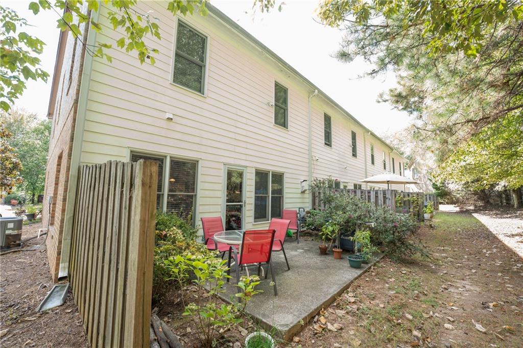 1665 Oakbrook Lake Drive Northwest Norcross, GA 30093 - Photo 24 of 24 a view of a house with sitting area and garden