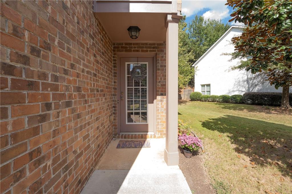 1665 Oakbrook Lake Drive Northwest Norcross, GA 30093 - Photo 4 of 24 a front view of a house with a yard