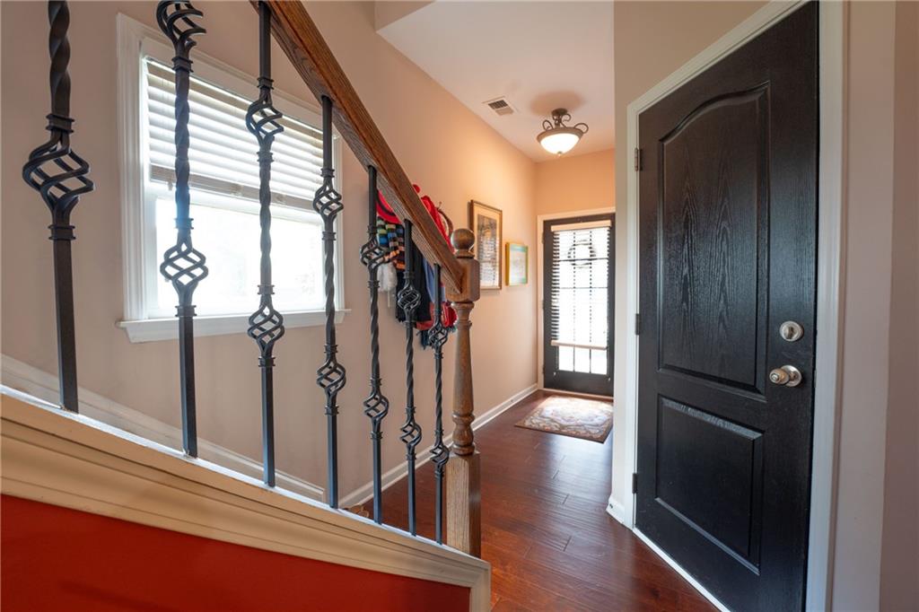 1665 Oakbrook Lake Drive Northwest Norcross, GA 30093 - Photo 5 of 24 a view of a hallway with wooden floor and stairs