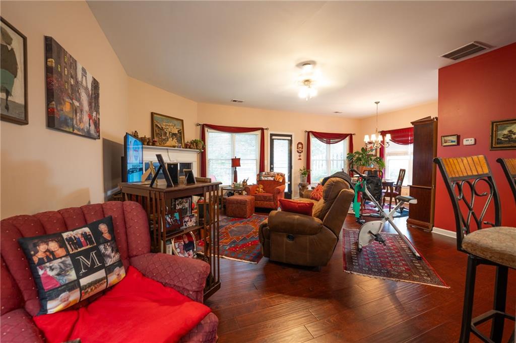 1665 Oakbrook Lake Drive Northwest Norcross, GA 30093 - Photo 6 of 24 a living room with furniture a rug and a flat screen tv