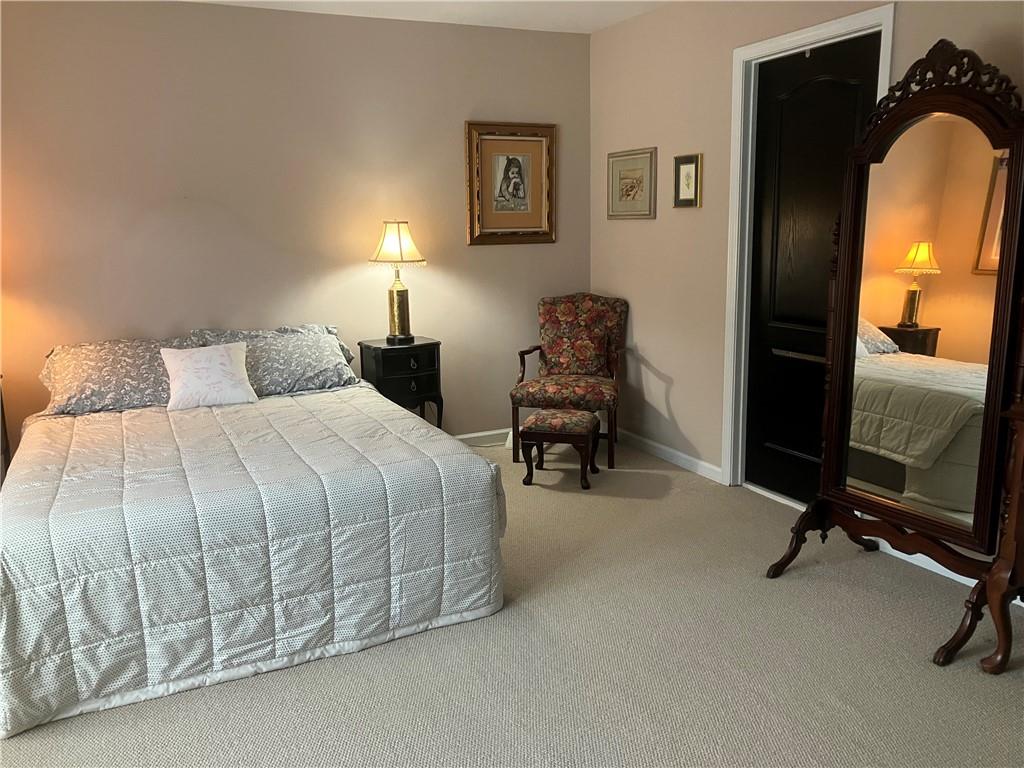 1665 Oakbrook Lake Drive Northwest Norcross, GA 30093 - Photo 7 of 24 a bedroom with a bed and a mirror