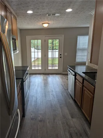 an empty room with wooden floor and a window