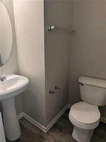 a white toilet sitting next to a bathroom sink