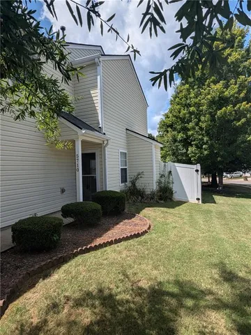 a backyard of a house with plants and trees
