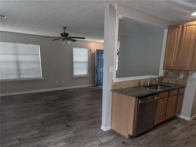 a kitchen with a sink and cabinets