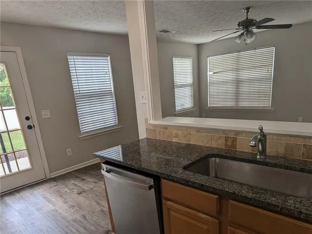 a kitchen with a sink stove and cabinets