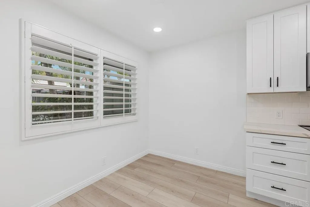 889 Bracero Road Encinitas, CA 92024 - Photo 7 of 59 a view of an empty room with a window and wooden floor