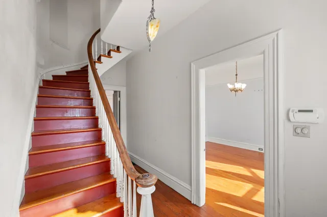 a view of entryway with wooden floor and stair