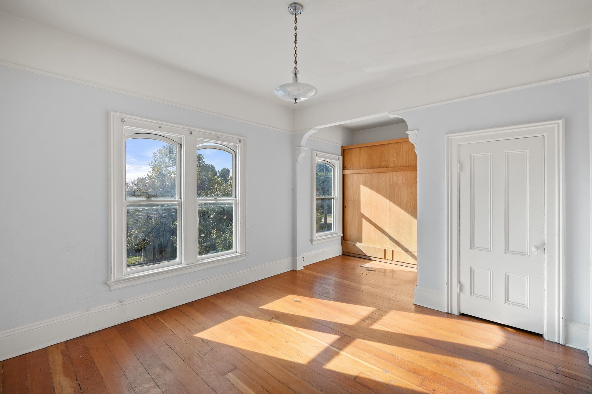 1746 8th Street Oakland, CA 94607 - Photo 19 of 52 a view of an empty room with a window and wooden floor