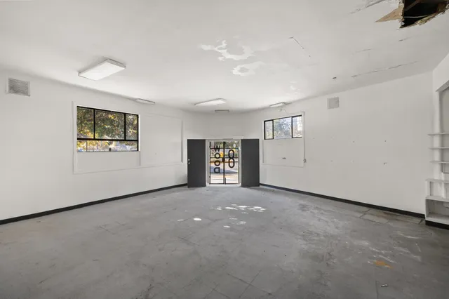 an empty room with closet and mirror