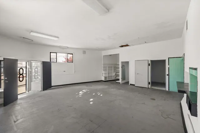 an empty room with furniture and white walls