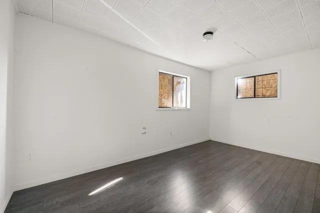 a view of a room with wooden floor and white walls