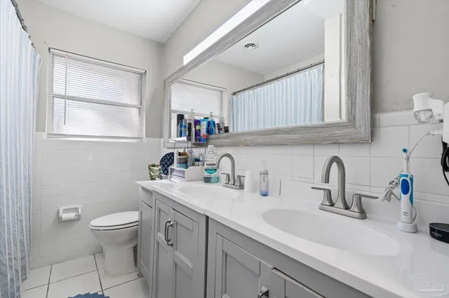 a bathroom with a sink a toilet and a window