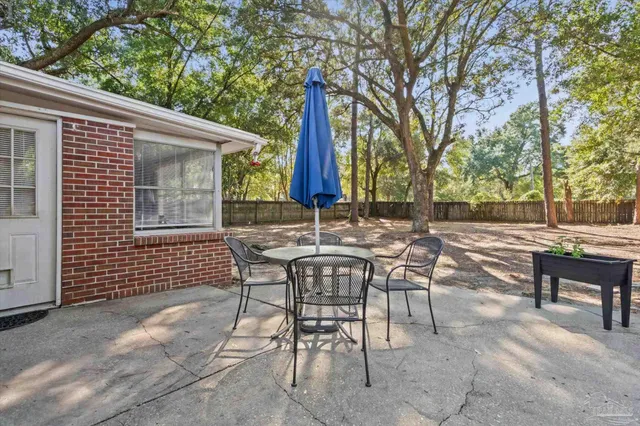 a view of a patio with a table and chairs and couches