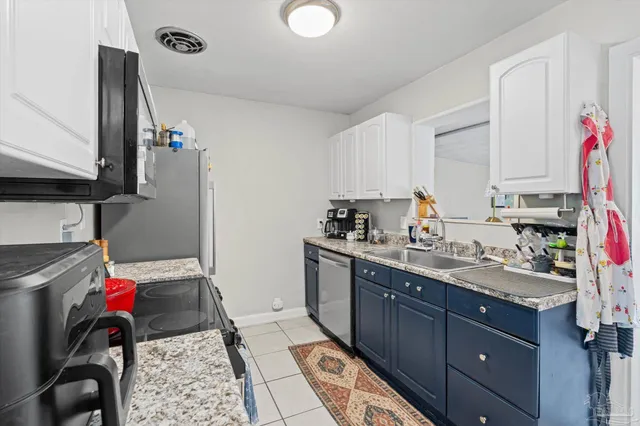 a kitchen with a sink cabinets and appliances