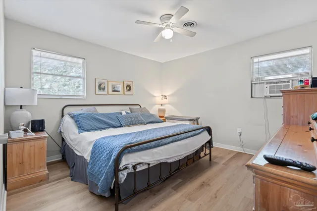 a spacious bedroom with a bed and a chandelier