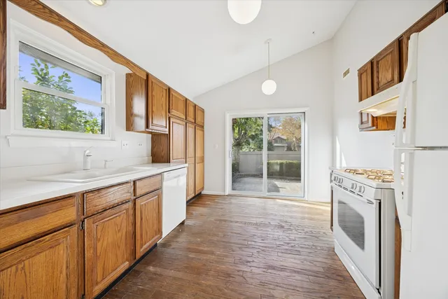 a large bathroom with a sink a washer and dryer next to a window