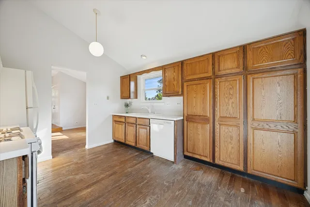 a view of a kitchen with stainless steel appliances wooden floor and a window