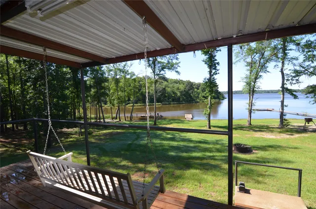 a view of a couches in patio with a yard