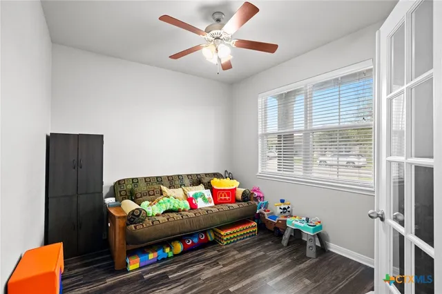 a bedroom with furniture and a small window