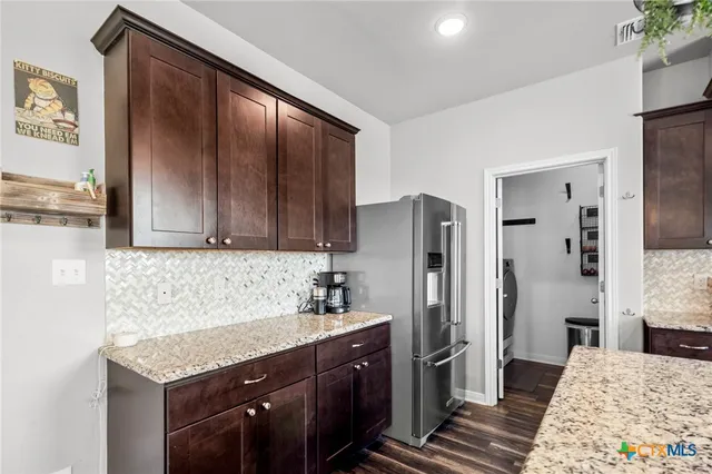 a kitchen with a refrigerator and countertop