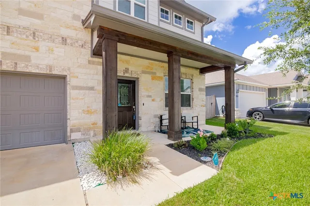 a front view of a house with garden