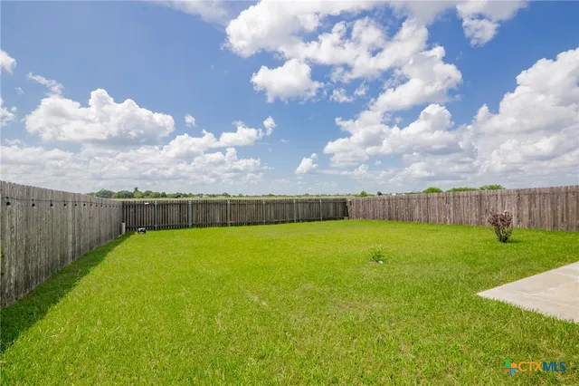 a view of a swimming pool with a yard