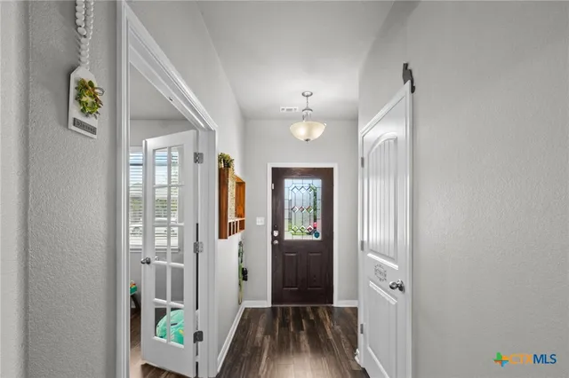 a view of hallway with wooden floor and stairs