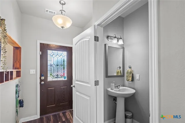 a bathroom with a sink a mirror and a shower