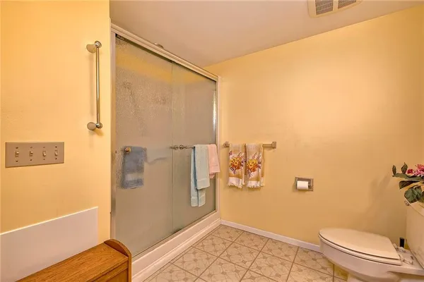 a bathroom with a toilet and a shower