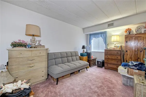 a living room with furniture and a dresser