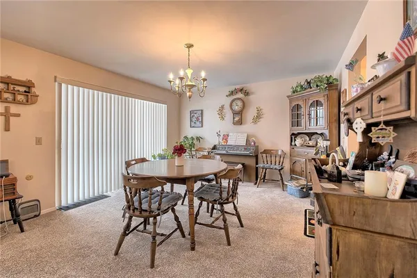a view of a dining room with furniture and chandelier