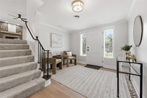a view of a livingroom with furniture and staircase