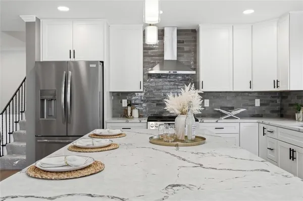 a kitchen with stainless steel appliances kitchen island granite countertop a sink and cabinets
