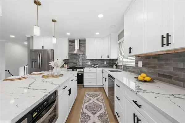 a kitchen with a sink stove and cabinets