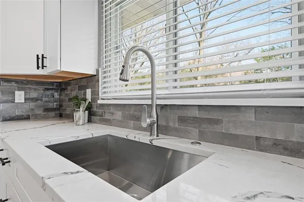a view of a kitchen with a sink and cabinets