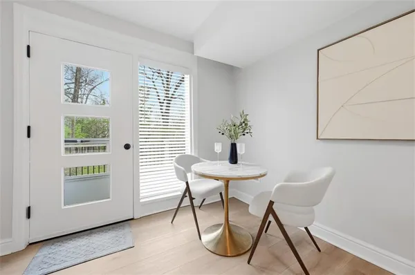 a view of a room that has a table and chair in it