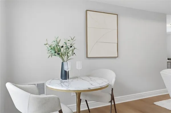 a dining room with furniture and wooden floor