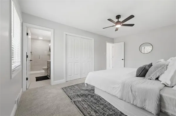 a bedroom with a large bed and vanity