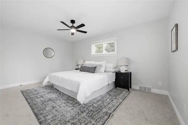a bedroom with a bed and a ceiling fan