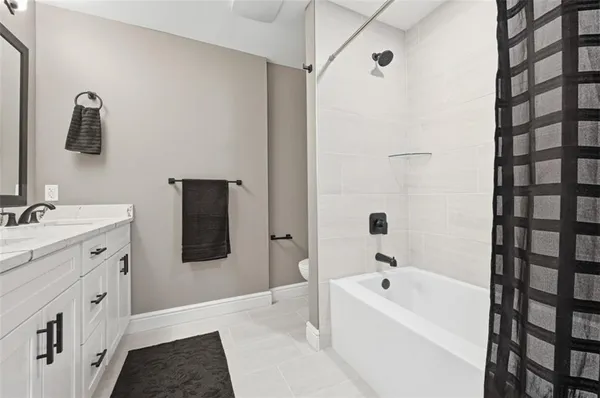 a bathroom with a double vanity sink and mirror