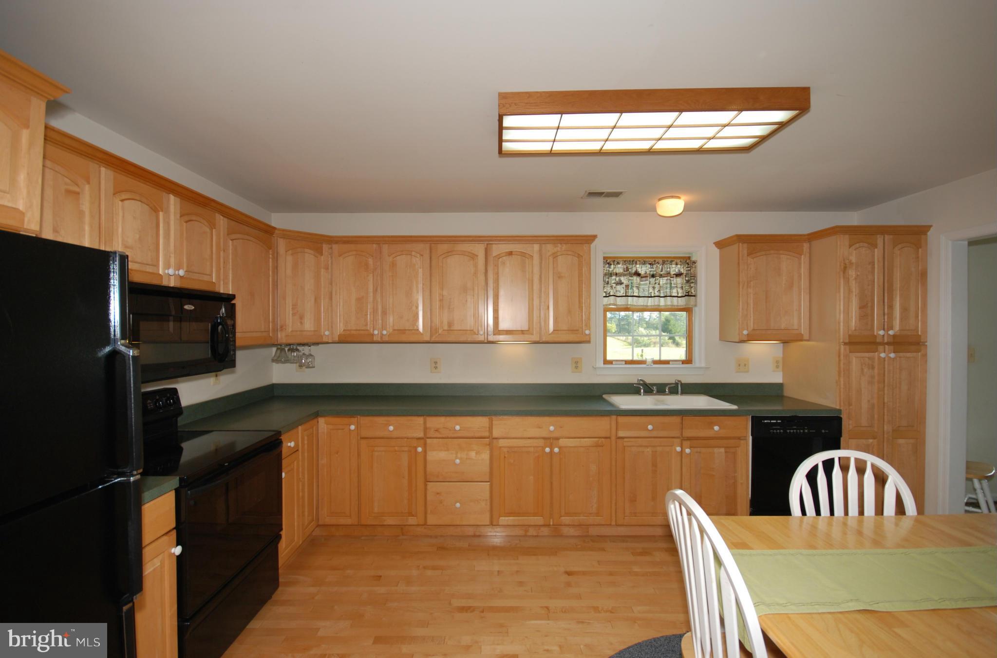 2118 Laurel Grove Road Winchester, VA 22602 - Photo 11 of 29 a kitchen with granite countertop a stove top oven a sink dishwasher a dining table and chairs