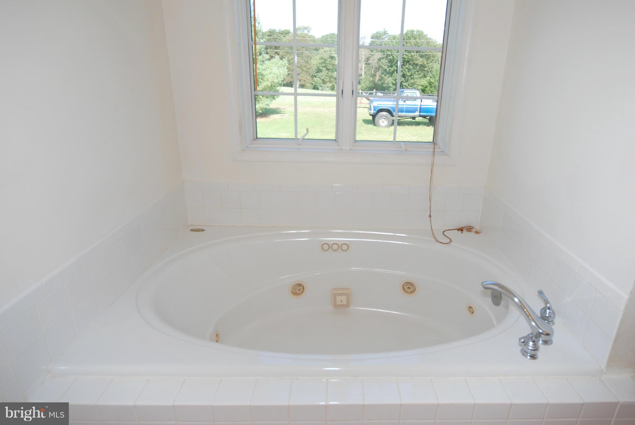 2118 Laurel Grove Road Winchester, VA 22602 - Photo 18 of 29 a white bath tub sitting in a bathroom