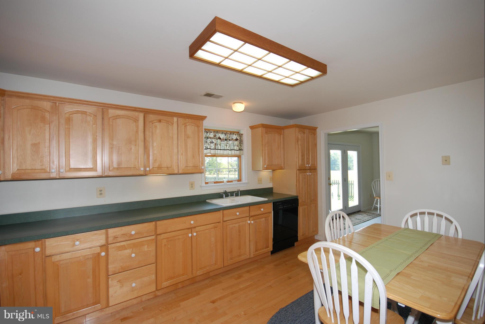 2118 Laurel Grove Road Winchester, VA 22602 - Photo 10 of 29 a kitchen with granite countertop a sink a stove cabinets dining table and chairs