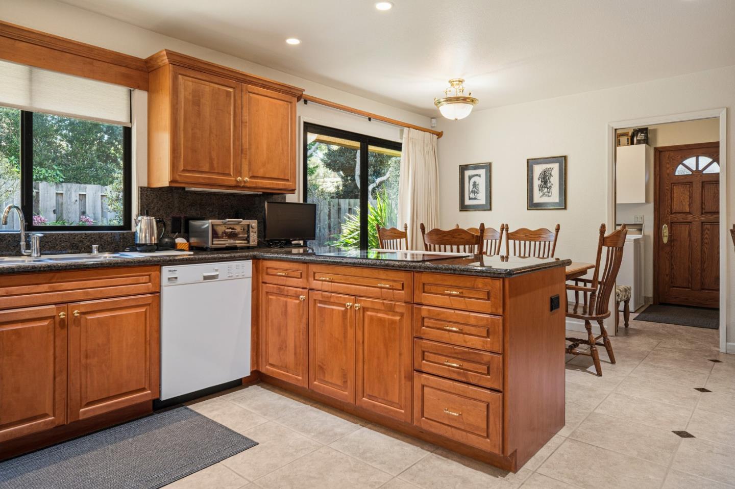 2911 Colton Road Pebble Beach, CA 93953 - Photo 18 of 46 a kitchen with granite countertop a sink cabinets and window