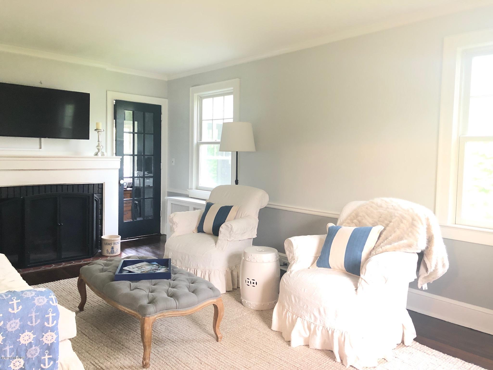 10 Lake Drive South, Unit SOUTH Riverside, CT 06878 - Photo 11 of 45 a living room with furniture a fireplace and a flat screen tv