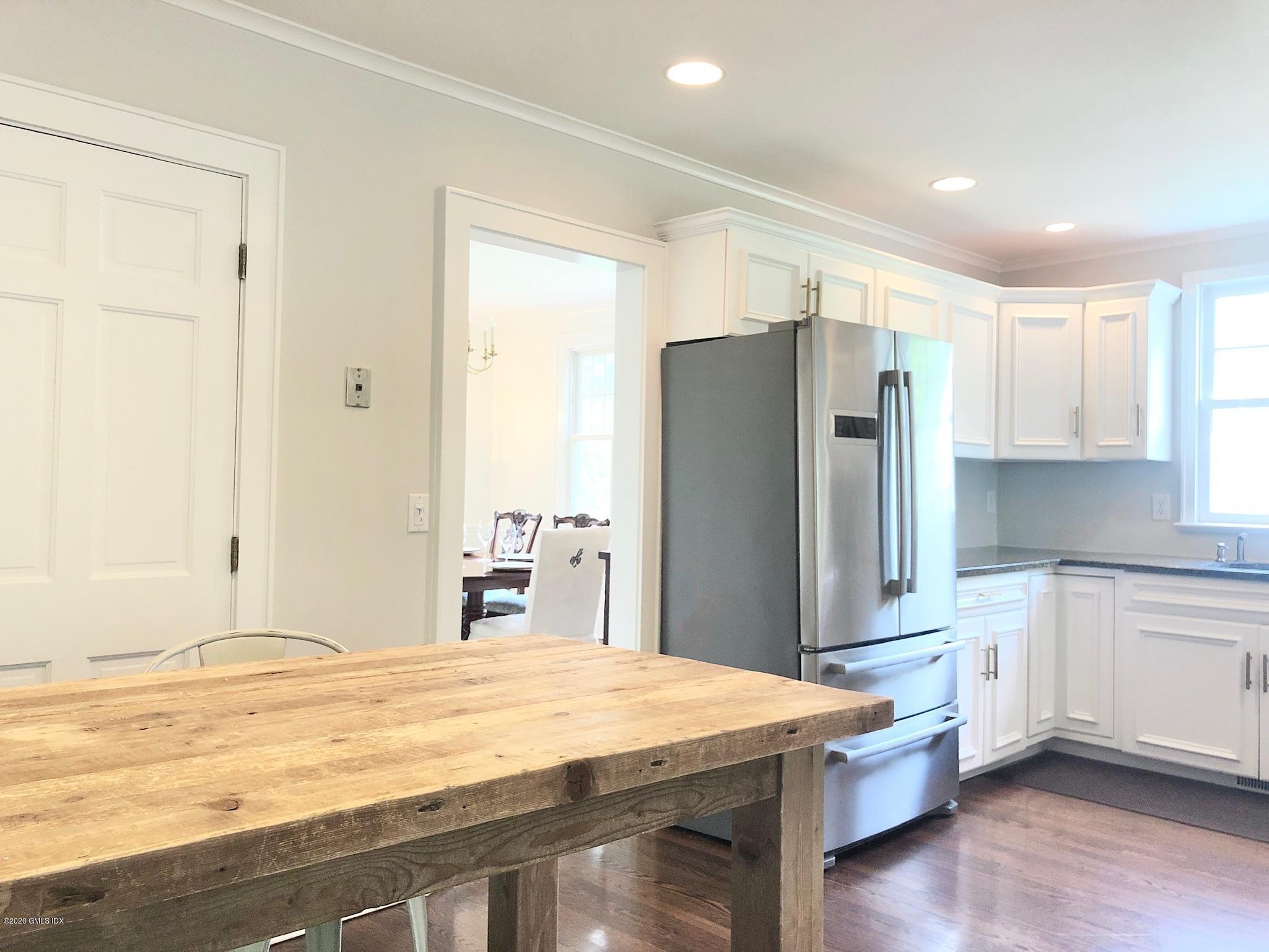 10 Lake Drive South, Unit SOUTH Riverside, CT 06878 - Photo 13 of 45 a kitchen with stainless steel appliances granite countertop a refrigerator sink and cabinets