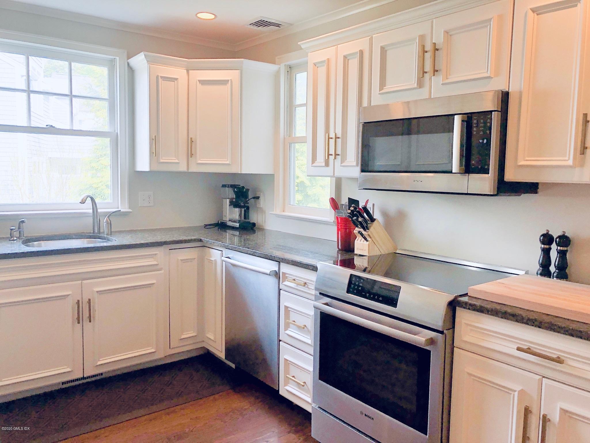10 Lake Drive South, Unit SOUTH Riverside, CT 06878 - Photo 14 of 45 a kitchen with cabinets appliances a sink and a window