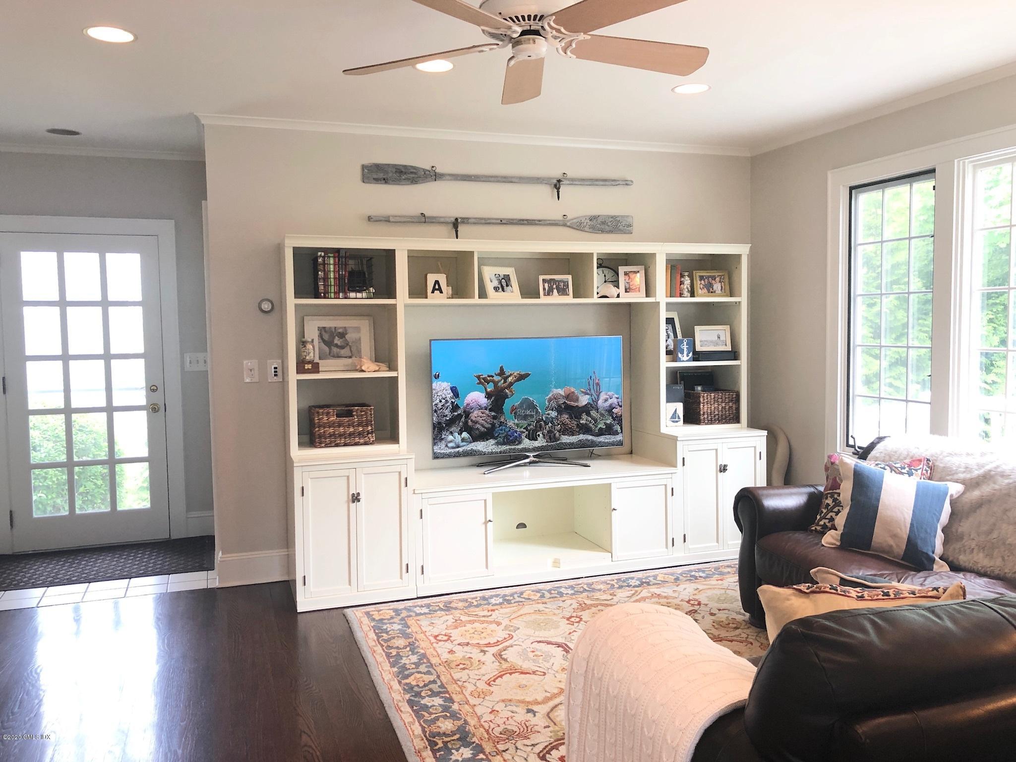 10 Lake Drive South, Unit SOUTH Riverside, CT 06878 - Photo 19 of 45 a living room with furniture and floor to ceiling windows