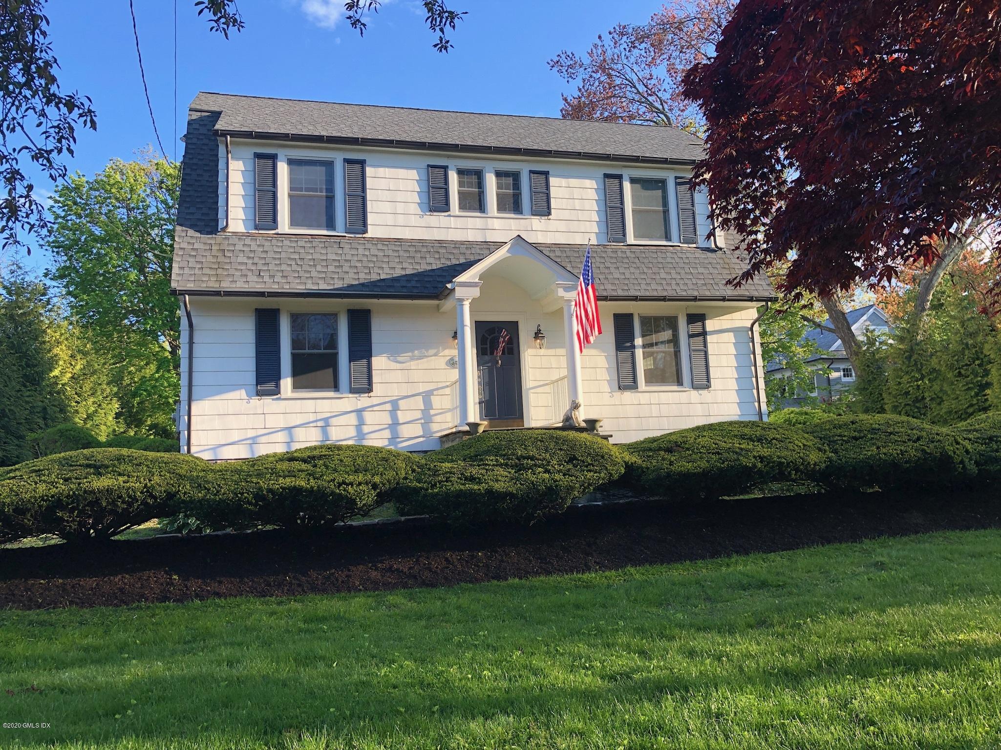 10 Lake Drive South, Unit SOUTH Riverside, CT 06878 - Photo 2 of 45 a front view of a house with a garden